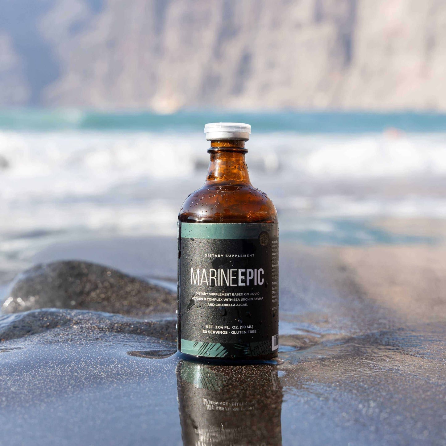 Marine Epic biotechnology supplement bottle on wet rock by the ocean for longevity and anti-aging biohacking