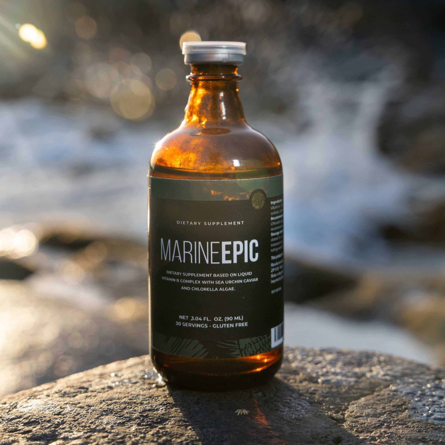 Marine Epic biotechnology supplement bottle on rock near water, promoting longevity and anti-aging benefits