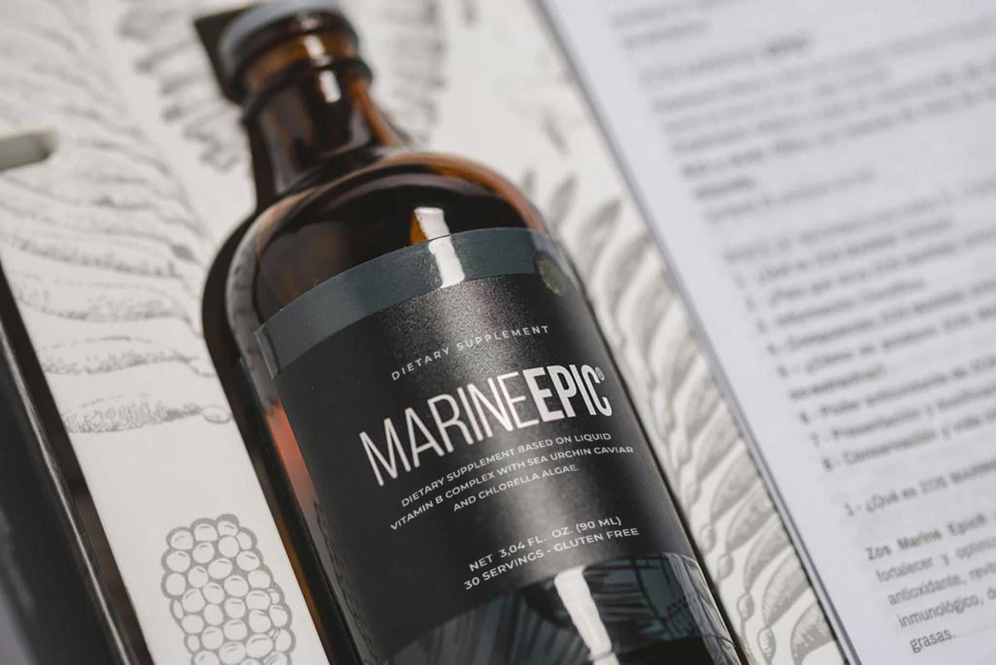 Marine Epic biotechnology supplement bottle on decorative background with informational text blurred nearby