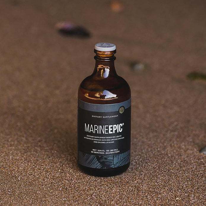 Bottle of Marine Epic biotechnology supplement for longevity and anti-aging on sandy surface